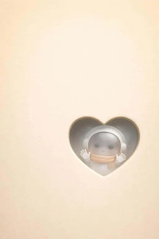 Portrait 2:3 minimalist wallpaper of a warm buttery gradient with paper grain, a beveled heart cutout revealing frosted glass and a peeking chibi astronaut.