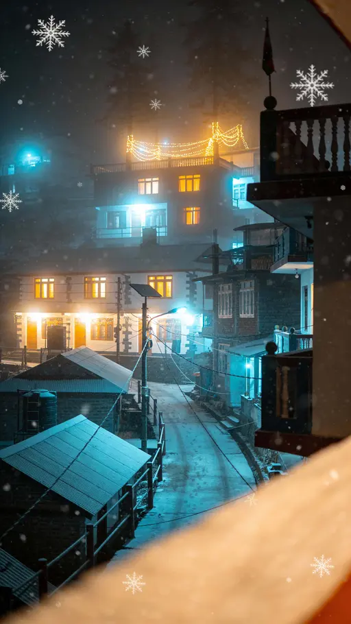 Portrait 9:16 view of foggy Darjeeling at Christmas night, vertical street with soft lamps glowing through mist and distant homestay windows warm amid gentle snowfall and cinematic depth.