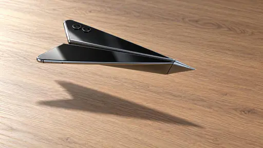 Airplane mode: a smartphone folded into a paper-airplane shape glides low over a bare desk, its black glass wing surfaces catching soft directional light, a silver metal rim tracing the folded edges and two small camera lenses set along one wing, side three-quarter view with a soft shadow of the…