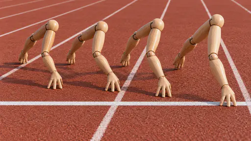 Arms race: playful sculptural sports photograph of four smooth articulated wooden mannequin arms sprinting side by side down miniature running-track lanes on their spread fingers, the leading arm one fingertip ahead at a white finish stripe, under bright studio light.