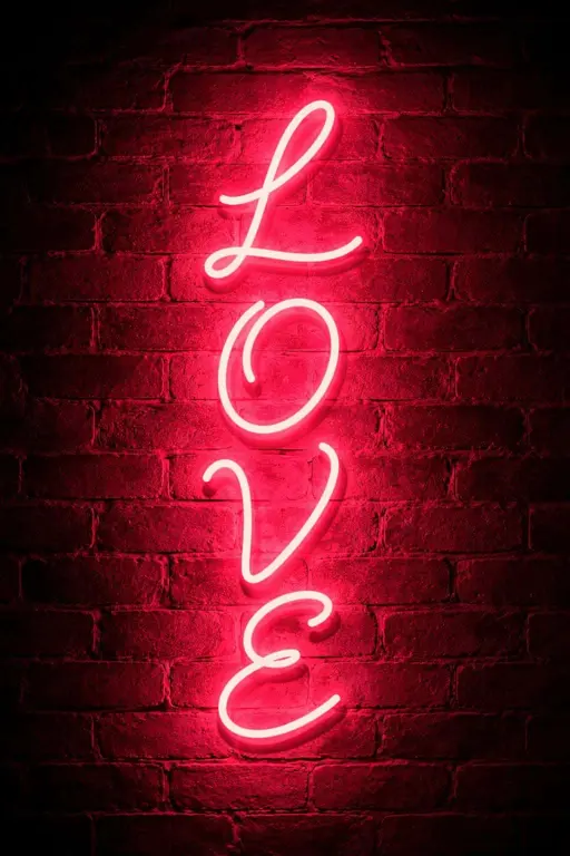 Cinematic vertical 2:3 night scene of stacked cursive 'L O V E' neon on a dark red brick wall, the intense pink halo saturates mortar and rough brick texture for an intimate, urban mood.