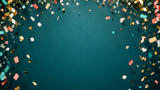 Gold, coral, teal and white paper confetti hanging in the air along the top and sides of a plain deep teal wall with curled streamers at the upper corners and a large empty area in the middle.