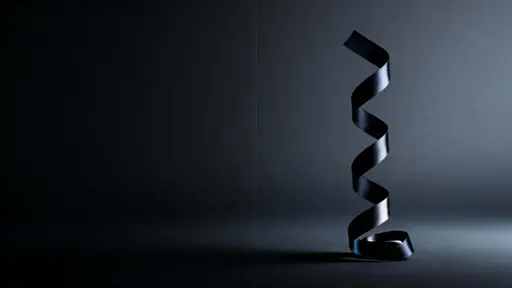 A matte-black ribbon twists upward on the center-right of a 16:9 frame, defined by soft upper-left rim light against expansive near-black negative space and subtle haze.