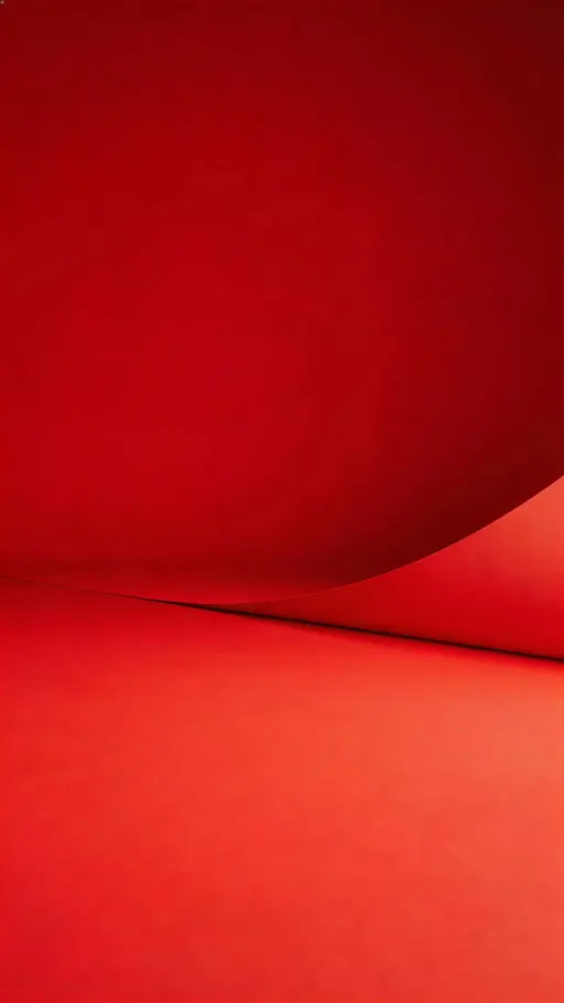 Vertical 9:16 studio product shot of a matte red seamless paper sweep with a smooth curve and soft diffusion, brightest zone in the lower half and a darker, uncluttered upper third for breathing room.