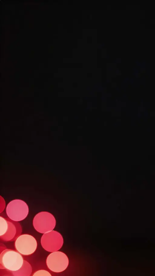 Cinematic 9:16 vertical wallpaper with soft clustered red bokeh orbs concentrated low and to one side, and a darker, uncluttered upper region left clear for icons.