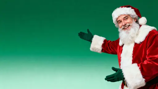 Contemporary 16:9 portrait of Santa from mid-torso up on the right, smiling at the camera with both arms gesturing—one inviting, one pointing to the empty left green gradient space for copy.