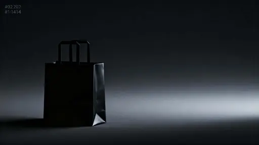 Ultra-minimal 16:9 3D render of a matte-black shopping bag on the left third, its velvety surfaces fading into near-black negative space across a calm, text-free frame.