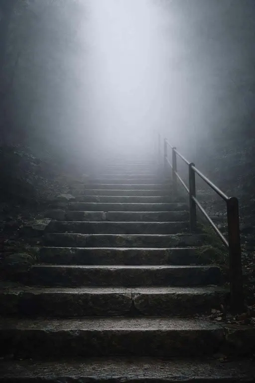Staircase vanishing into dense fog captured as a vertical 2:3 fine-art composition with strong leading lines, minimalist mood and poster or wallpaper intent.