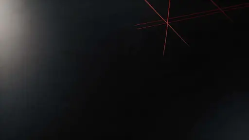16:9 widescreen wallpaper of a sparse, off-center crimson tech grid etched into matte glass, fading into deep near-black negative space for icons.
