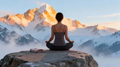 A woman sits cross-legged on a rocky outcrop facing snow-capped peaks at golden sunrise, breath visible in misty cold, with cinematic photoreal clarity conveying peaceful, spiritual calm.